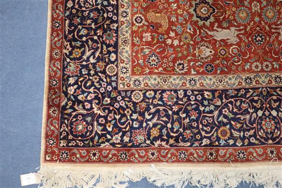 An Indian red and blue ground carpet 319 x 153cm